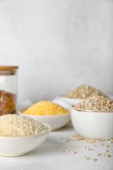 Bowls with cereals on light background