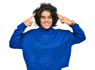 Young hispanic woman with curly hair wearing turtleneck sweater smiling pointing to head with both hands finger, great idea or thought, good memory
