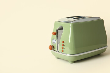 Modern toaster on beige background