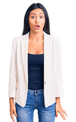 Young beautiful latin girl wearing business clothes scared and amazed with open mouth for surprise, disbelief face