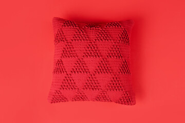 Stylish decorative pillow on red background