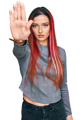 Young caucasian woman wearing casual clothes doing stop sing with palm of the hand. warning expression with negative and serious gesture on the face.