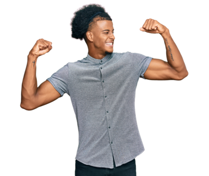 African american man with afro hair wearing casual clothes showing arms muscles smiling proud. fitness concept. - Powered by Adobe