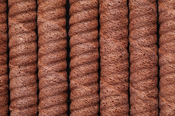 Delicious chocolate wafer rolls as background