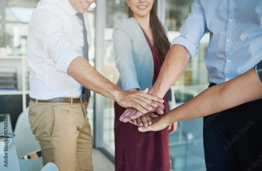 Poster to win, youve gotta go all in. shot of a group of colleagues joining their hands together in solidar