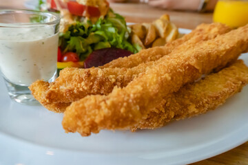 Fish and chips on white plate for lunch