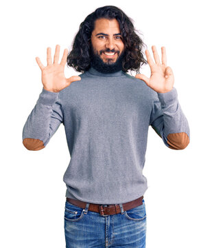 Young arab man wearing casual clothes showing and pointing up with fingers number nine while smiling confident and happy.