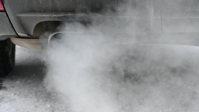 Smoke from car exhaust. Heavy air pollution. Exhaust fumes, close up. Smoke emission from vehicle. 