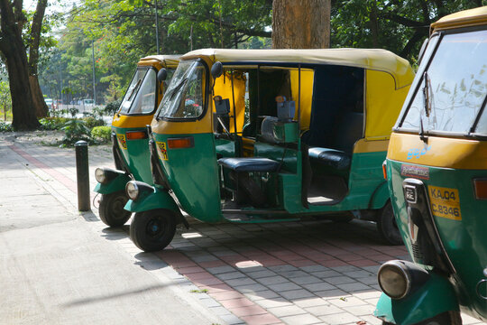 Three auto rickshaws on the street in Bangalore, Karnataka, India on December 21, 2022.