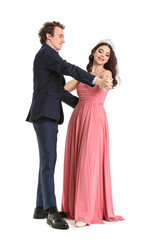 Beautiful couple dressed for prom dancing on white background
