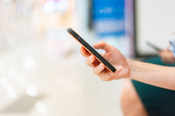 Portrait of hand holding mobile phones. Person is playing and touch screen telephone. Telephone is a modern communication technology.