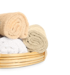 Fototapeta na wymiar Wicker basket with rolled bath towels isolated on white