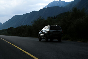 Fototapeta na wymiar Beautiful view of car on asphalt highway in mountains. Road trip