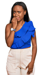 Young black woman wearing casual clothes looking stressed and nervous with hands on mouth biting nails. anxiety problem.