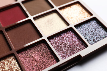 Beautiful eye shadow palette on white table, closeup