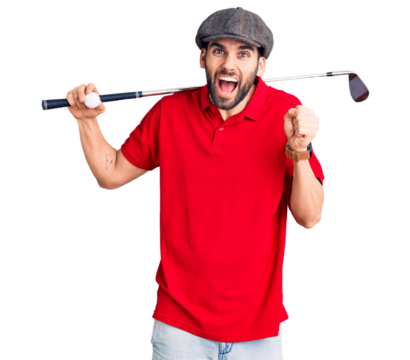 Young handsome man with beard playing golf holding club and ball screaming proud, celebrating victory and success very excited with raised arms