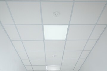 White ceiling with modern lighting in room, low angle view