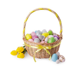 Wicker basket with beautifully painted Easter eggs and tulips isolated on white