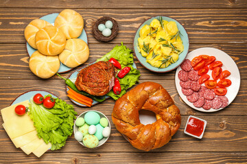 Tasty dishes for Easter dinner on wooden table