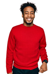 Young african american man with beard wearing casual winter sweater with a happy and cool smile on...