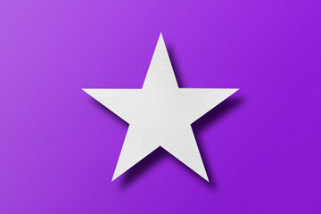 Obraz premium paper cut star shape with light and shadow Placed on a purple paper background.