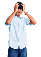 Young african american man wearing casual clothes suffering from headache desperate and stressed because pain and migraine. hands on head.