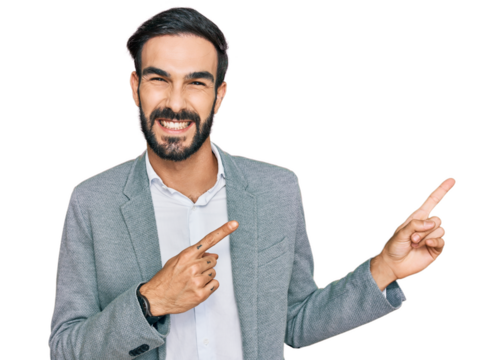 Young hispanic man wearing business clothes smiling and looking at the camera pointing with two hands and fingers to the side.