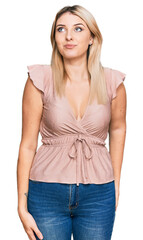 Fototapeta premium Young caucasian woman wearing casual clothes smiling looking to the side and staring away thinking.