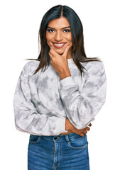 Young latin transsexual transgender woman wearing casual clothes looking confident at the camera smiling with crossed arms and hand raised on chin. thinking positive.