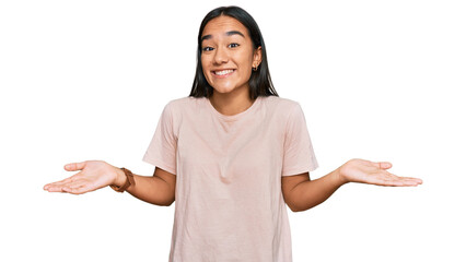 Young asian woman wearing casual clothes clueless and confused expression with arms and hands...