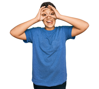 Teenager hispanic boy wearing casual clothes doing ok gesture like binoculars sticking tongue out, eyes looking through fingers. crazy expression.