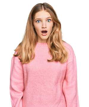 Beautiful young caucasian girl wearing casual winter sweater afraid and shocked with surprise expression, fear and excited face.