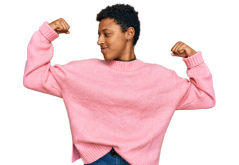 Young african american woman wearing casual clothes showing arms muscles smiling proud. fitness concept.