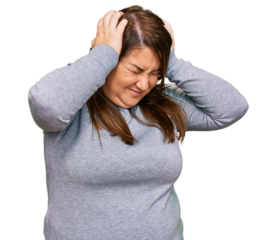 Beautiful brunette plus size woman wearing casual clothes suffering from headache desperate and stressed because pain and migraine. hands on head.