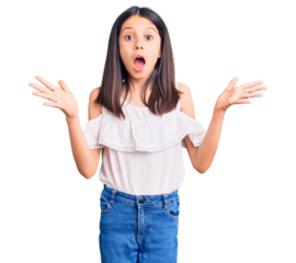 Beautiful child girl wearing casual clothes celebrating crazy and amazed for success with arms raised and open eyes screaming excited. winner concept