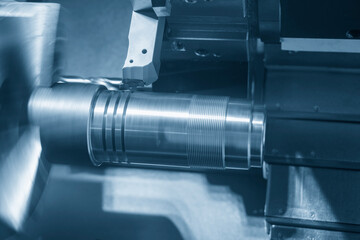 The  CNC lathe machine forming  cutting the metal shaft parts.