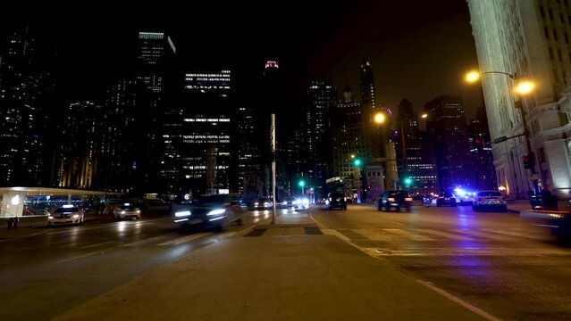 Night time lapse of Chicago streets downtown. the cars in traffic left trails of lights as they speed by on the expressway in this urban expressway 