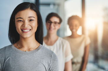 Guiding her team to greatness. Cropped shot of a group of businesspeople standing in the office.