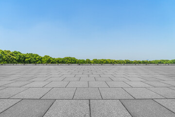 Empty square floor and green forest in summer season.