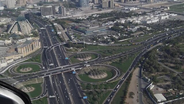 Dubai UAE, Helicopter Cockpit POV of Highway Traffic and Buildings, Tilt Up