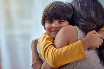 The purest love of all. Shot of an adorable little boy affectionately hugging his mother at home.
