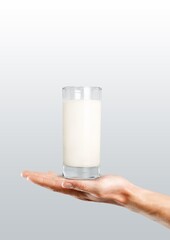 Hand holding glass of fresh milk