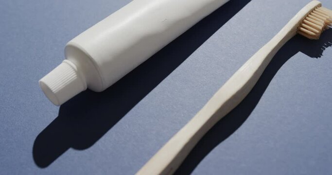 Close up of toothbrush and toothpaste on blue background
