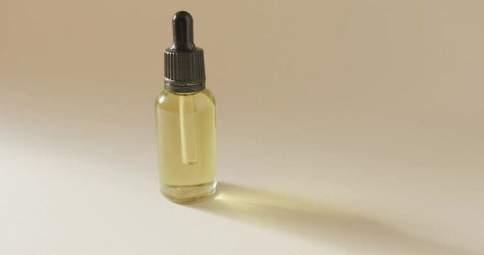 Close up of glass bottle with pump and copy space on grey background
