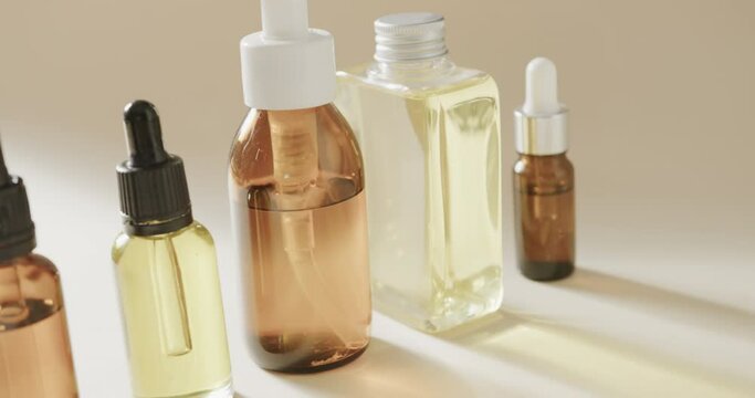 Close up of glass bottles with pumps with copy space on grey background