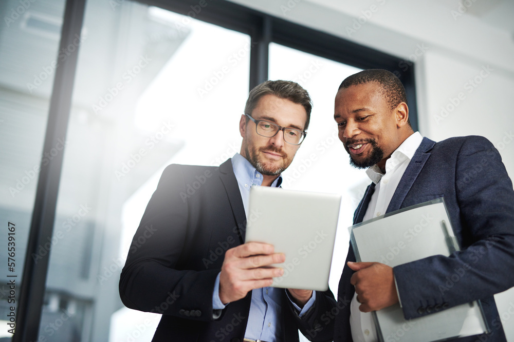 Poster interactive collaborations with the help of wireless technology. shot of two businessmen using a dig