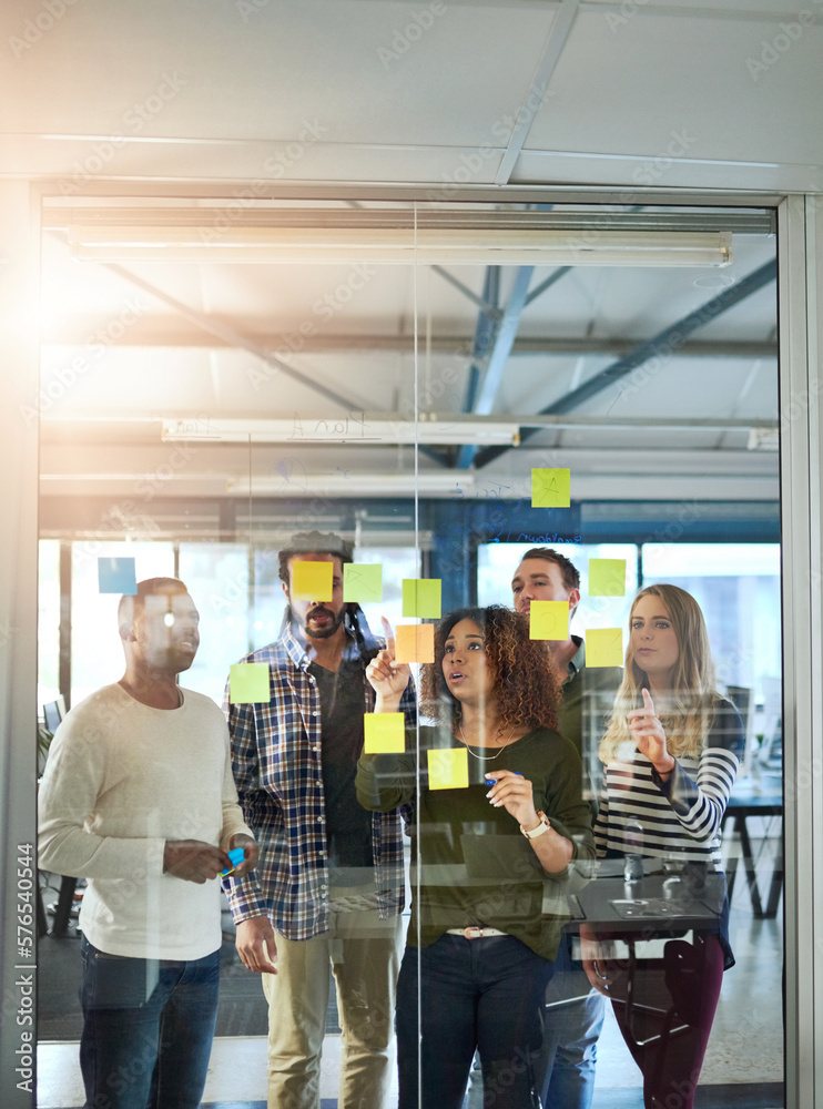 Leinwandbilder Harnessing the mind power of a team. Shot of colleagues having a brainstorming session with sticky notes at work.