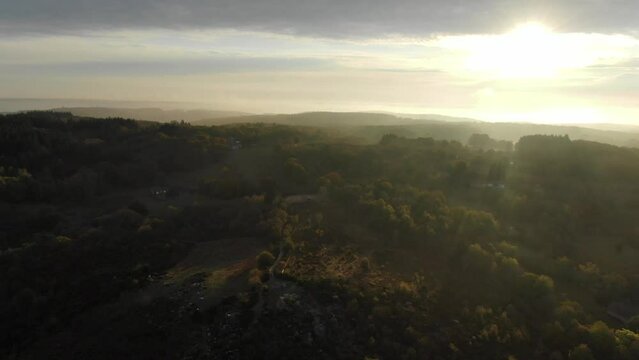 Sunlight over countryside of Uchon, Saone-et-Loire department in France. Aerial drone view