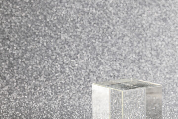 transparent podium for product display on silver glittering background. pedestal, stage for...