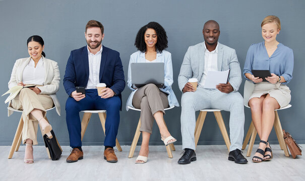 Business people, diversity and networking in row for recruitment, interview or corporate meeting at office. Group of diverse candidates sitting in waiting room working with technology for team hiring